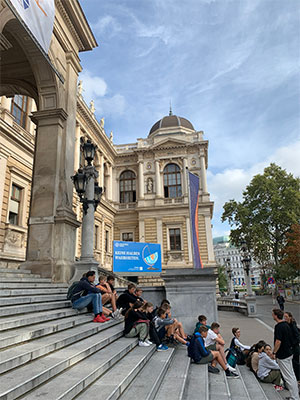 Students sitting outside a building in Vienna