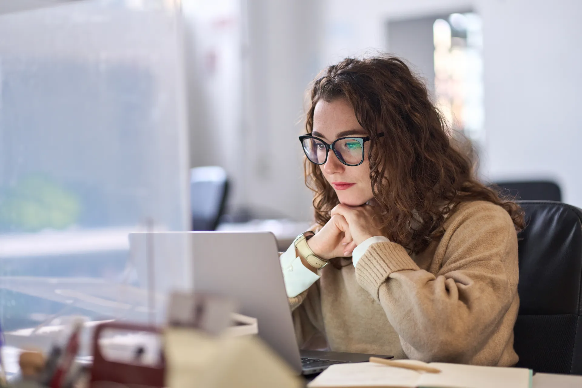 A woman sitting in front of a laptop