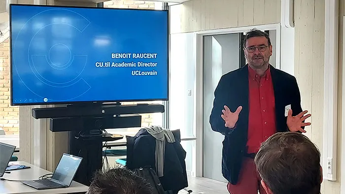 Man standing next to a TV