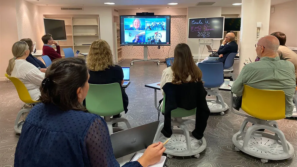 Back of the heads of people watching a screen