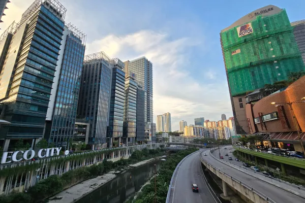 A cityscape with a motorway in between high rises.