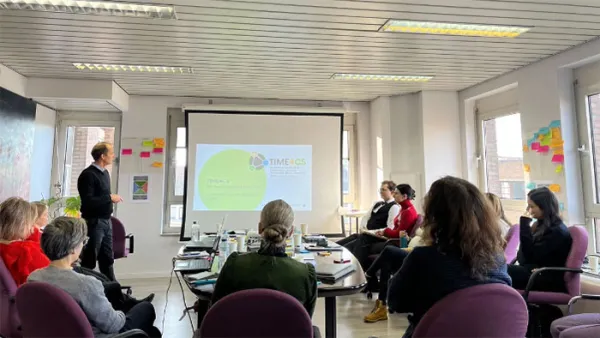 People watching a presentation in a meeting room