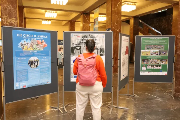 Person looking at a poster in an exhibition. 